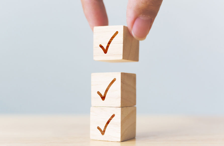 stacking wooden cubes with checkmark